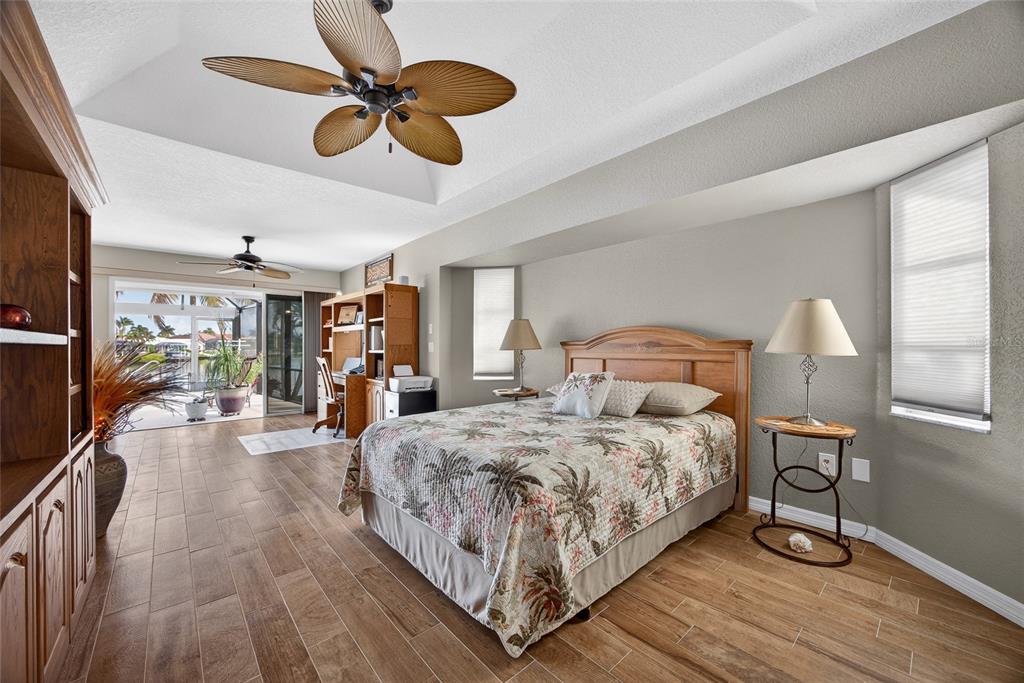 3612 Whippoorwill Boulevard Punta Gorda, FL 33950 - Photo 14 of 40 a bedroom with bed and a chandelier