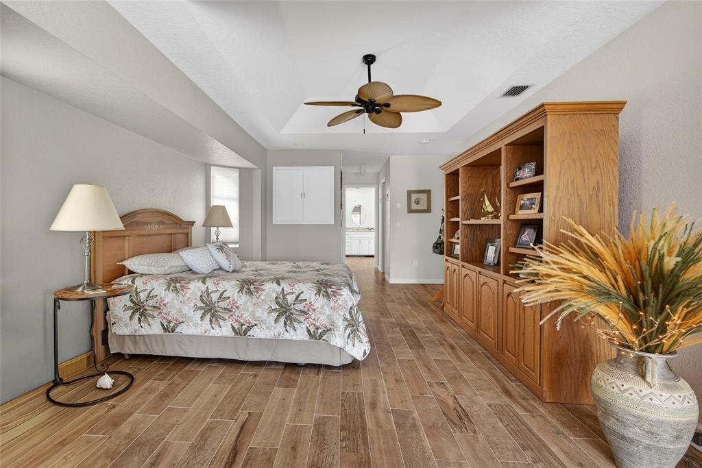 3612 Whippoorwill Boulevard Punta Gorda, FL 33950 - Photo 16 of 40 a bedroom with furniture and a chandelier