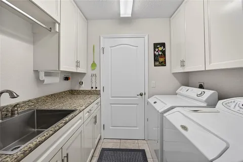 a view of a kitchen with sink and cabinets