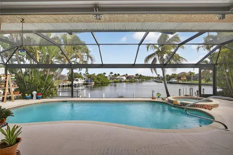 a view of a swimming pool with a bench in patio
