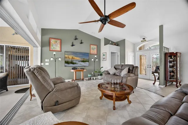 a living room with furniture a rug and a chandelier