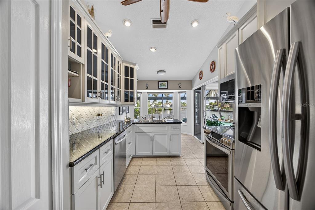 3612 Whippoorwill Boulevard Punta Gorda, FL 33950 - Photo 10 of 40 a kitchen with stainless steel appliances granite countertop a refrigerator and a sink