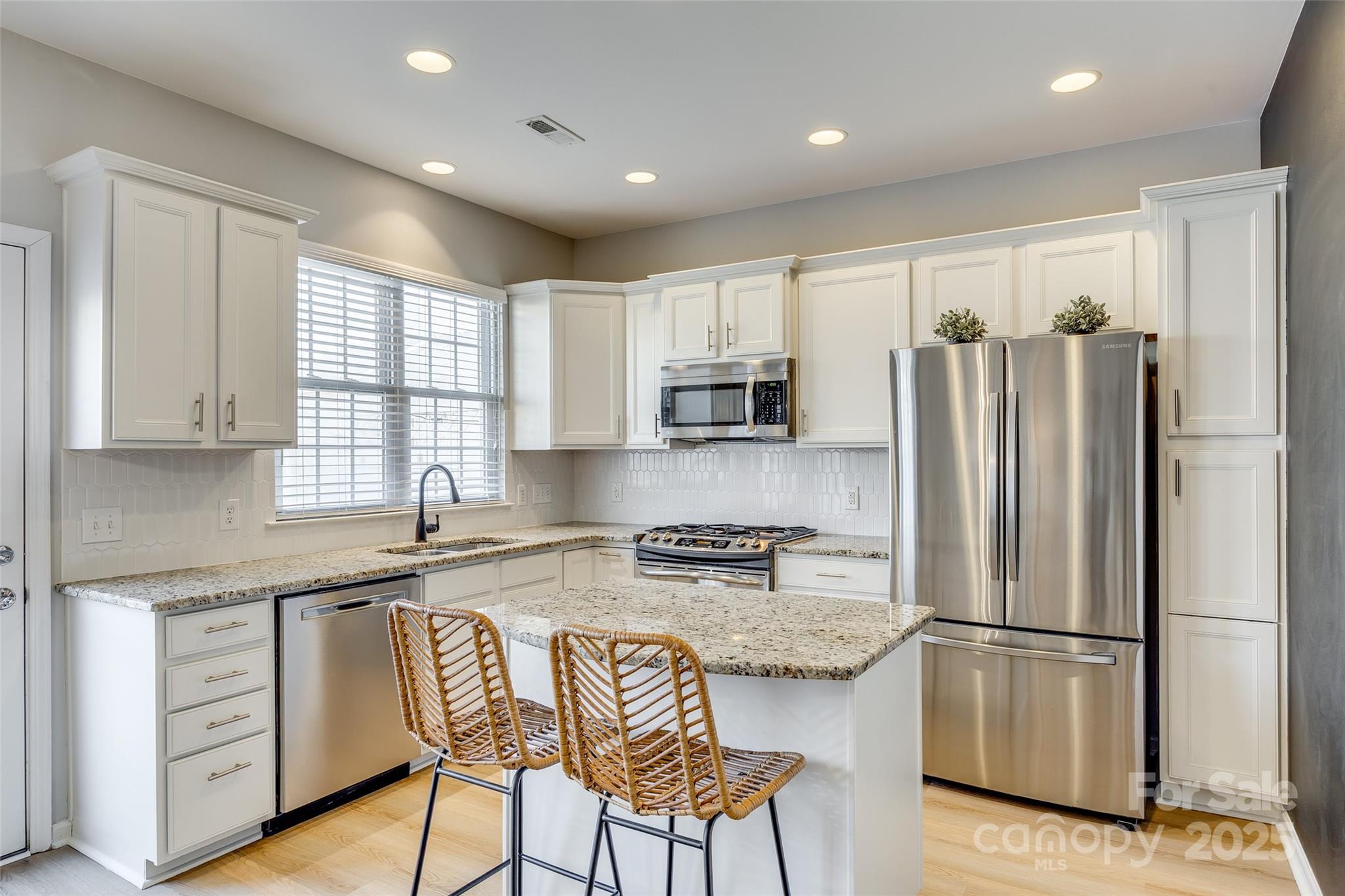 663 6th Baxter Crossing Fort Mill, SC 29708 - Photo 11 of 38 a kitchen with stainless steel appliances granite countertop a refrigerator a stove a sink and a microwave