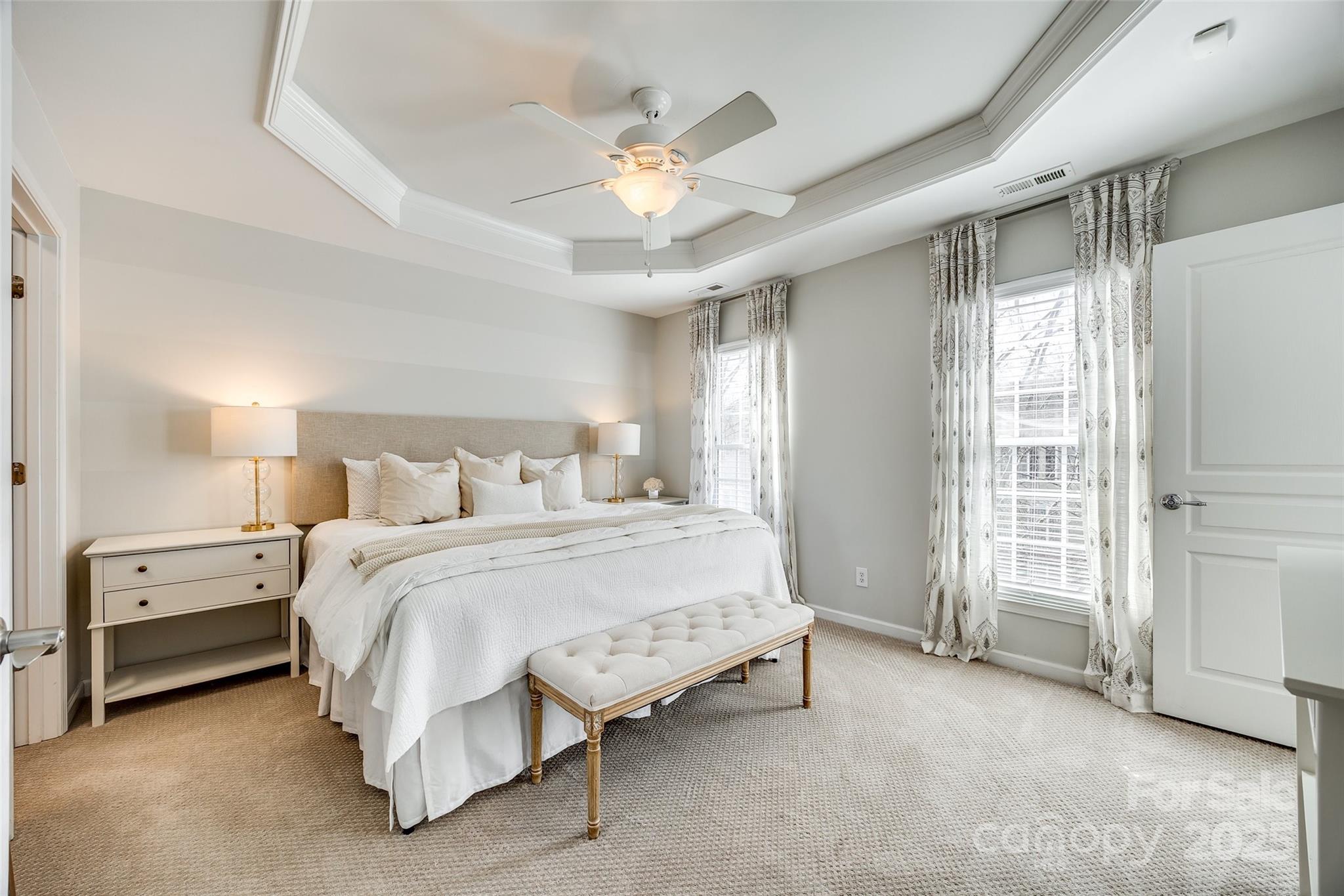 663 6th Baxter Crossing Fort Mill, SC 29708 - Photo 17 of 38 a spacious bedroom with a bed and a ceiling fan