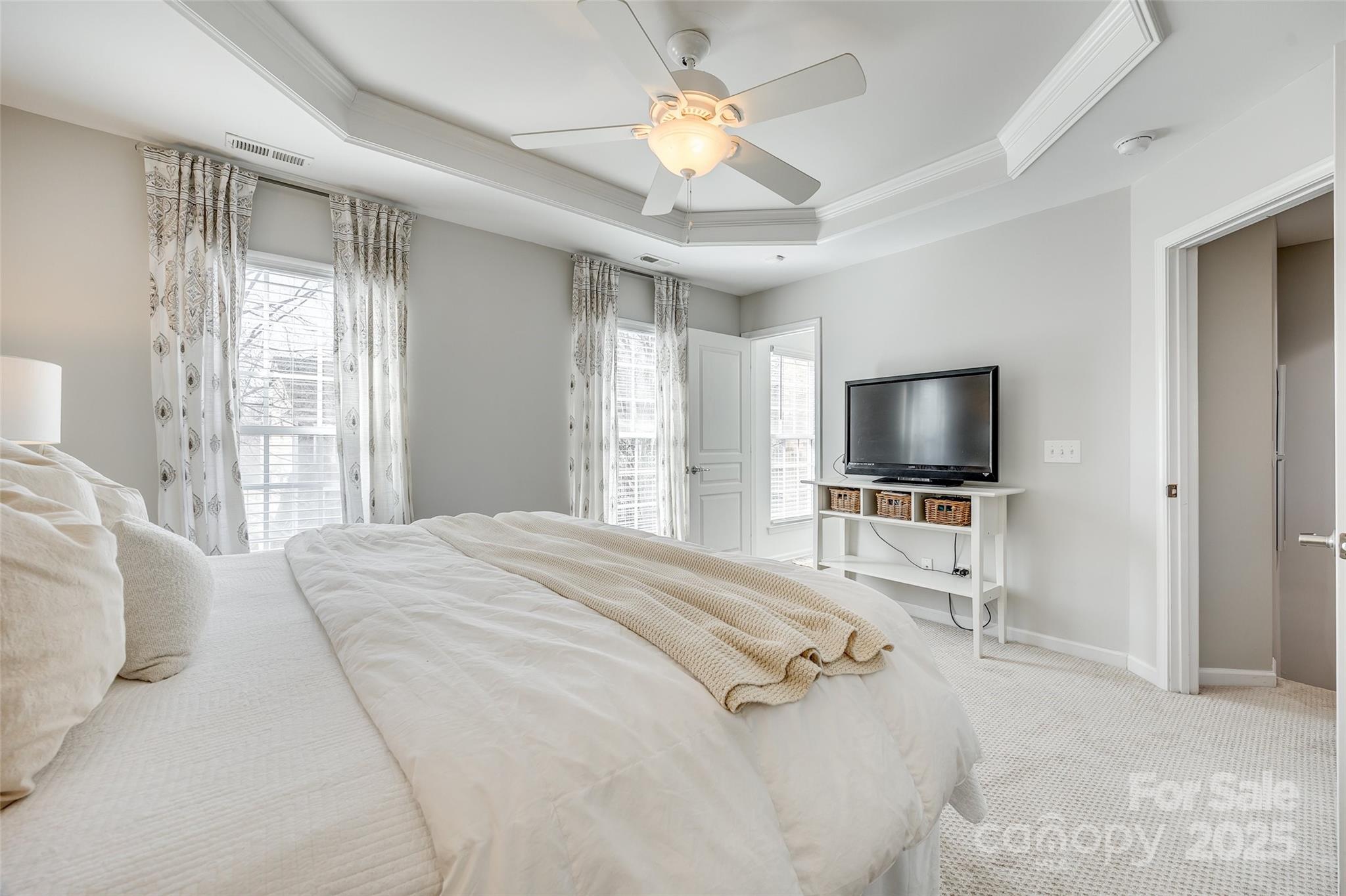 663 6th Baxter Crossing Fort Mill, SC 29708 - Photo 19 of 38 a bedroom with a bed and a flat screen tv