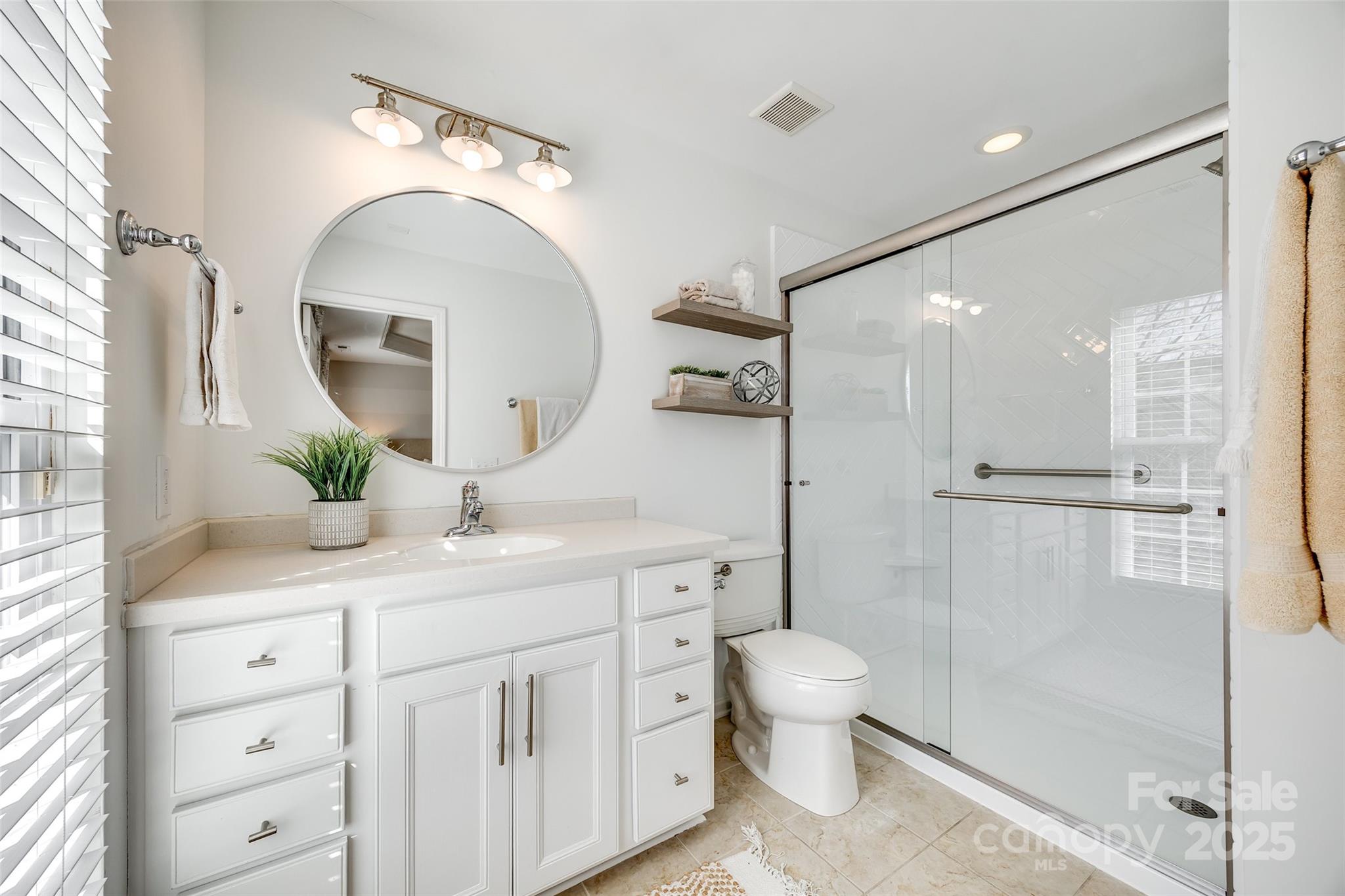 663 6th Baxter Crossing Fort Mill, SC 29708 - Photo 20 of 38 a spacious bathroom with a double vanity sink toilet mirror and windows