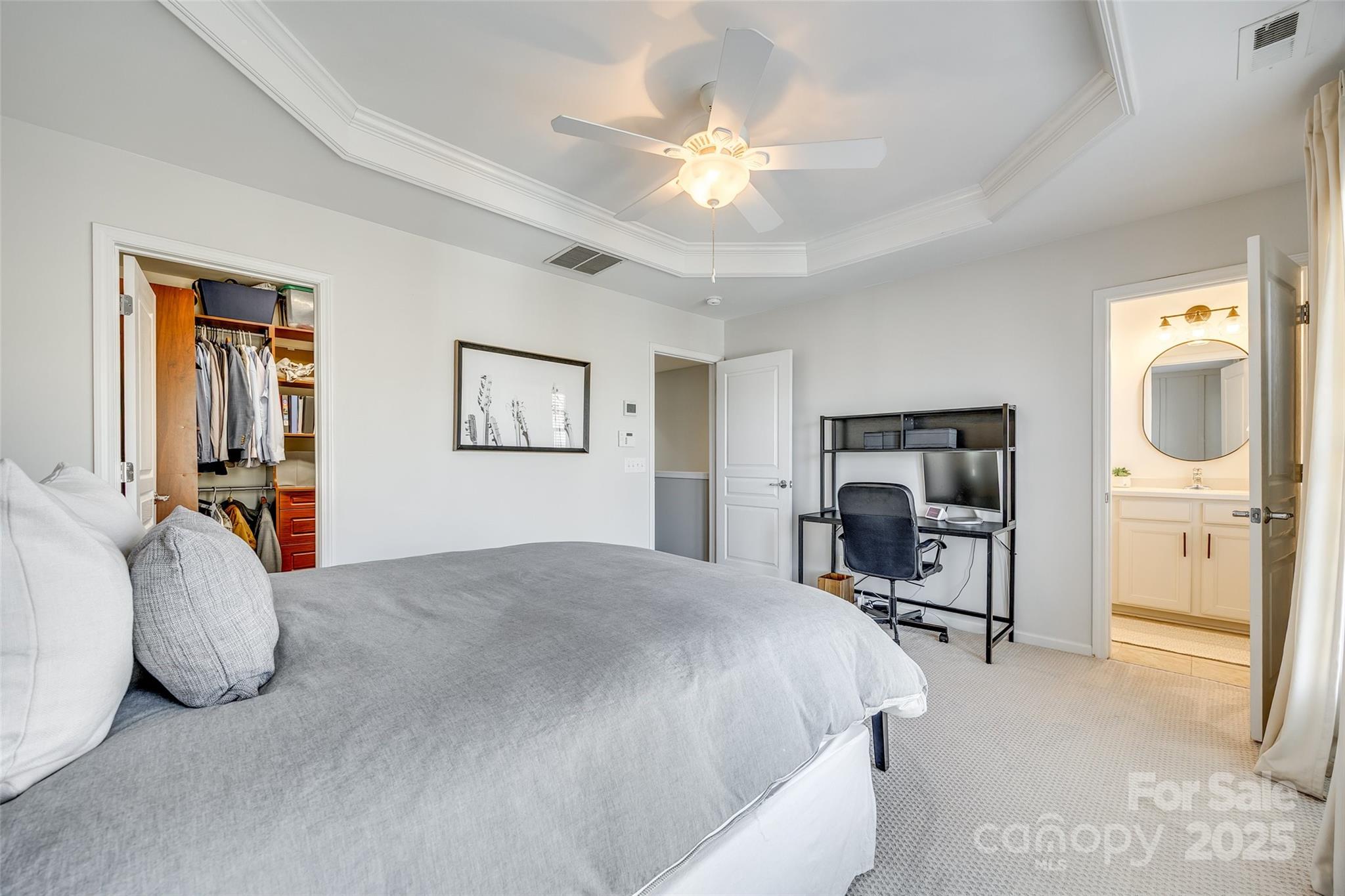 663 6th Baxter Crossing Fort Mill, SC 29708 - Photo 23 of 38 a spacious bedroom with a bed a mirror on dresser and a chandelier