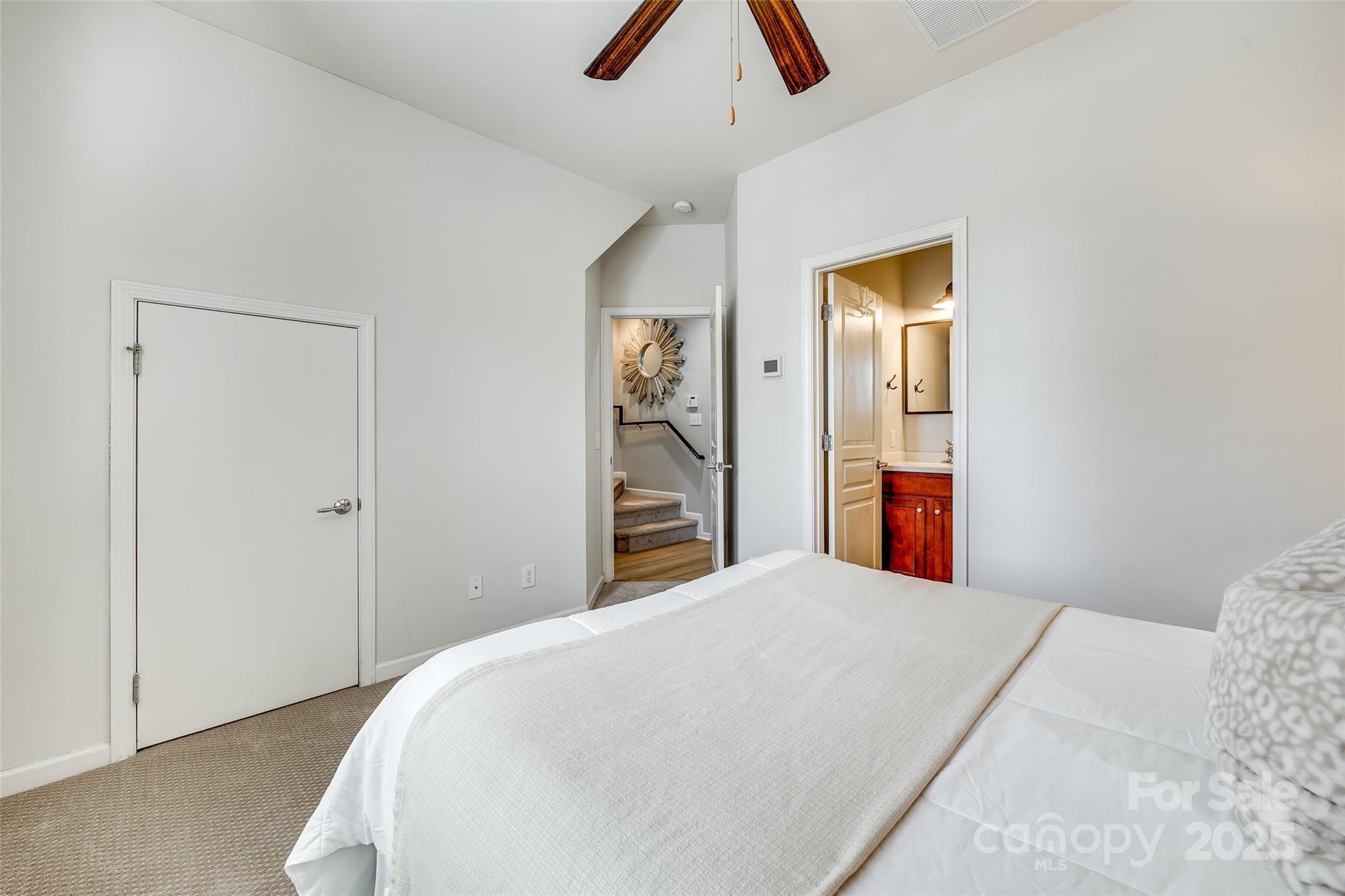 663 6th Baxter Crossing Fort Mill, SC 29708 - Photo 32 of 38 a bedroom with a bed and a chandelier