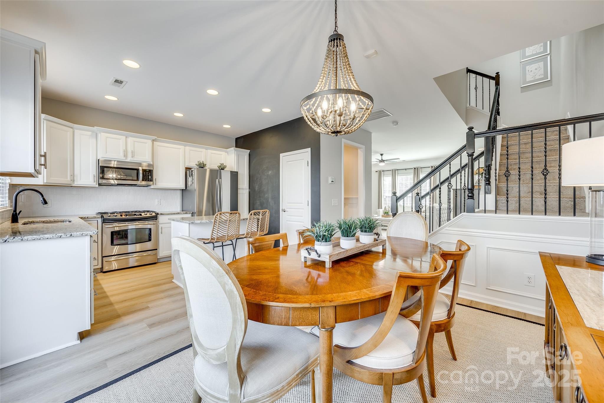 663 6th Baxter Crossing Fort Mill, SC 29708 - Photo 10 of 38 a view of a dining room with furniture a chandelier and wooden floor