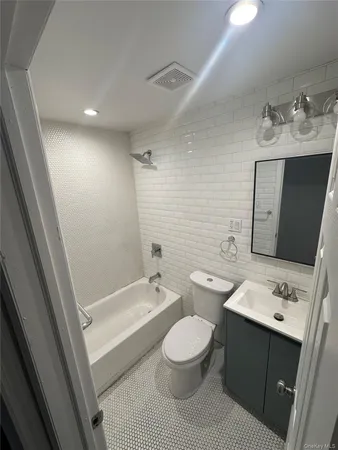 a bathroom with a double vanity sink toilet and shower