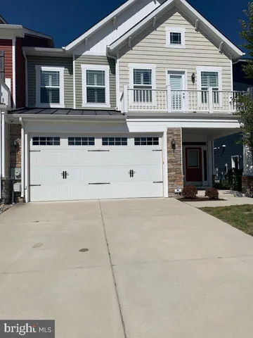 a view of a white house with large windows