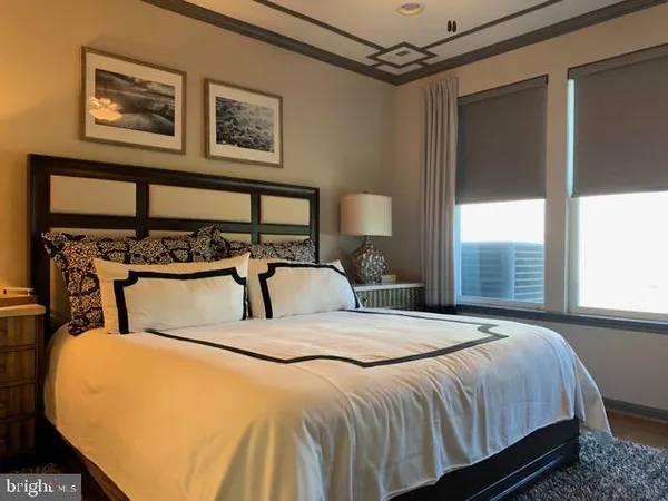 a bedroom with a bed next to a window