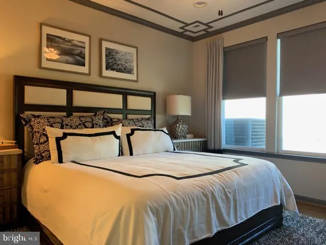 a bedroom with a bed next to a window