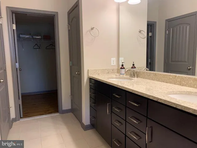 a bathroom with a sink double vanity and a mirror