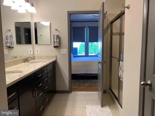 a en suite bathroom with a sink a vanity and a mirror