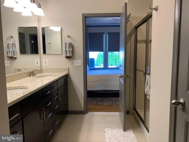 a en suite bathroom with a sink a vanity and a mirror