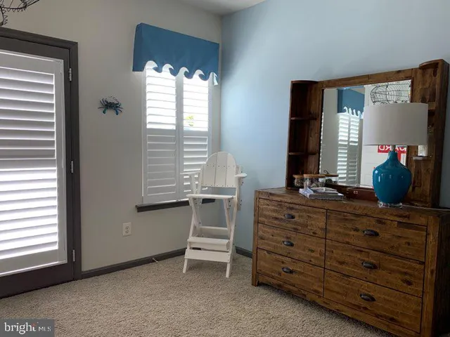 a room with a dresser and a window