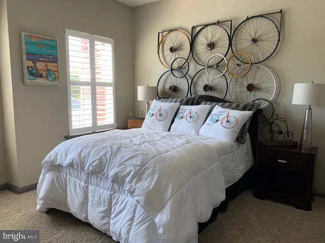 a bedroom with a bed and dresser with mirror