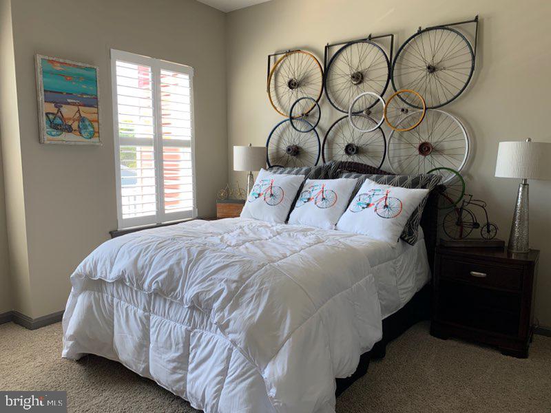 13 Basin Cove Way, Unit T82L Ocean View, DE 19970 - Photo 27 of 28 a bedroom with a bed and dresser with mirror