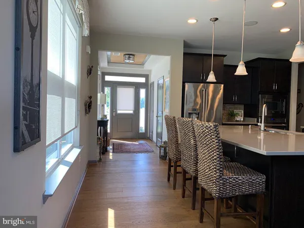 a dining room with furniture and wooden floor