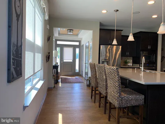 a dining room with furniture and wooden floor
