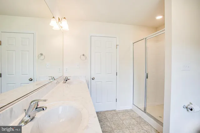 a spacious bathroom with a tub shower and sink
