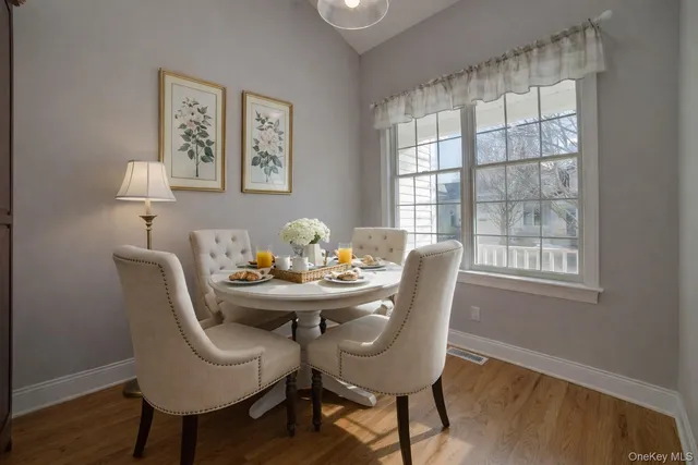 a dining room with furniture and wooden floor
