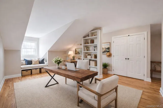 a living room with furniture and a book shelf