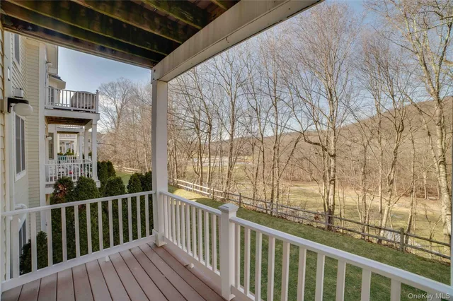 a view of a balcony with wooden floor and fence