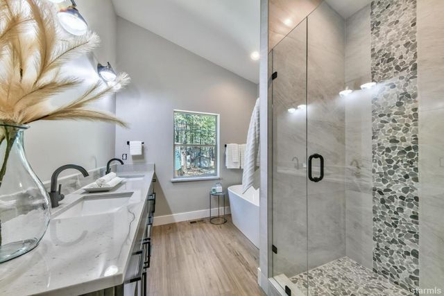 a bathroom with a granite countertop sink toilet and shower