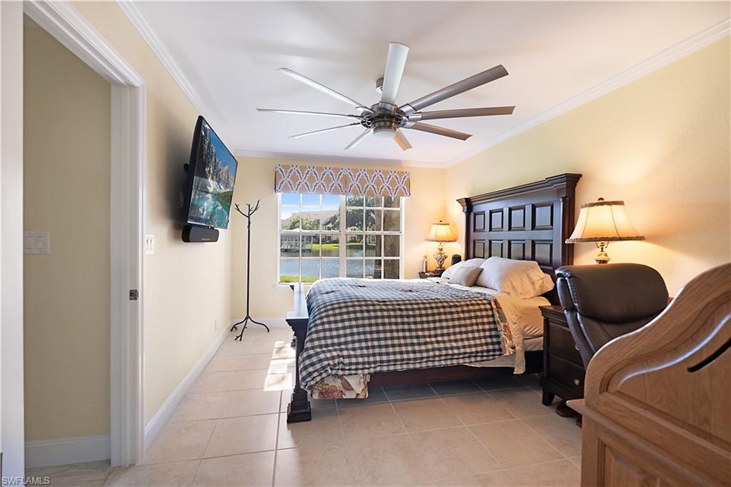 2008 Rookery Bay Drive, Unit 1102 Naples, FL 34114 - Photo 13 of 34 a bedroom with a bed lamp and a window