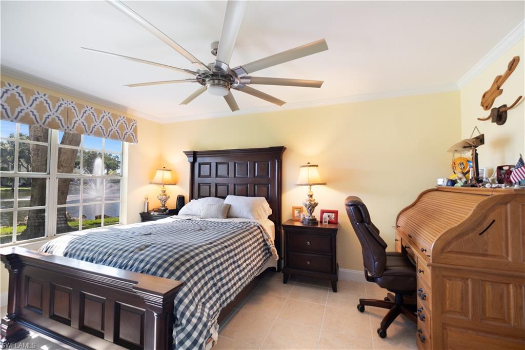 2008 Rookery Bay Drive, Unit 1102 Naples, FL 34114 - Photo 14 of 34 a bedroom with a bed a desk and chair with the wooden floor