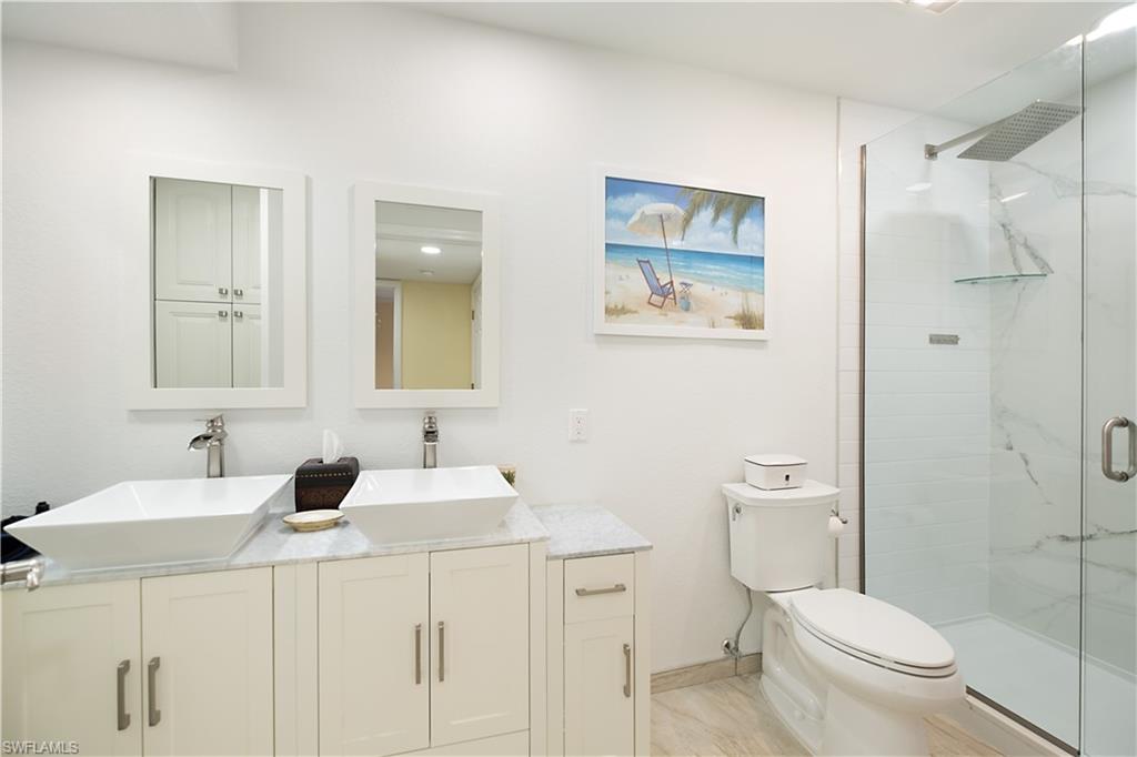 2008 Rookery Bay Drive, Unit 1102 Naples, FL 34114 - Photo 17 of 34 a bathroom with a sink toilet and shower