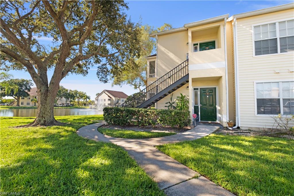 2008 Rookery Bay Drive, Unit 1102 Naples, FL 34114 - Photo 2 of 34 a view of a house with a yard