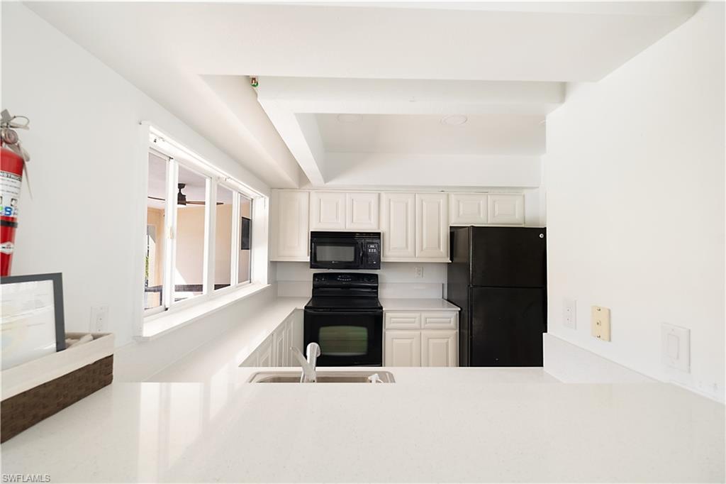 2008 Rookery Bay Drive, Unit 1102 Naples, FL 34114 - Photo 29 of 34 a living room with furniture and a flat screen tv