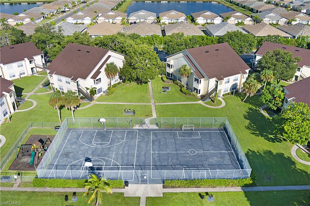 2008 Rookery Bay Drive, Unit 1102 Naples, FL 34114 - Photo 30 of 34 an aerial view of a house with a garden and swimming pool