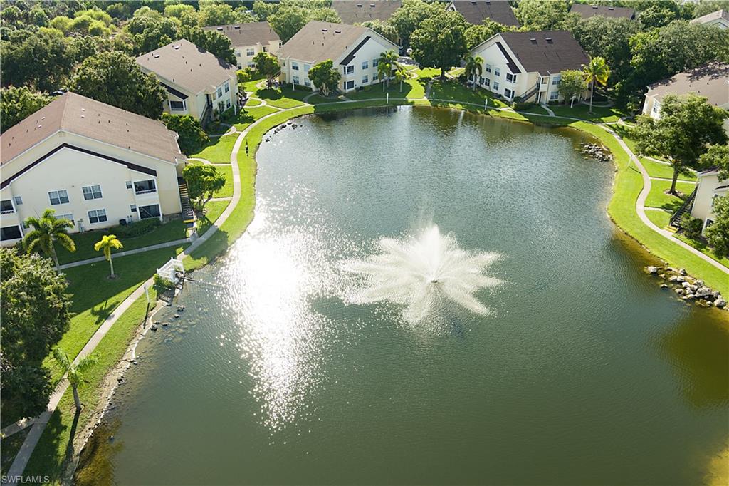 2008 Rookery Bay Drive, Unit 1102 Naples, FL 34114 - Photo 34 of 34 a view of a lake with a house in the background