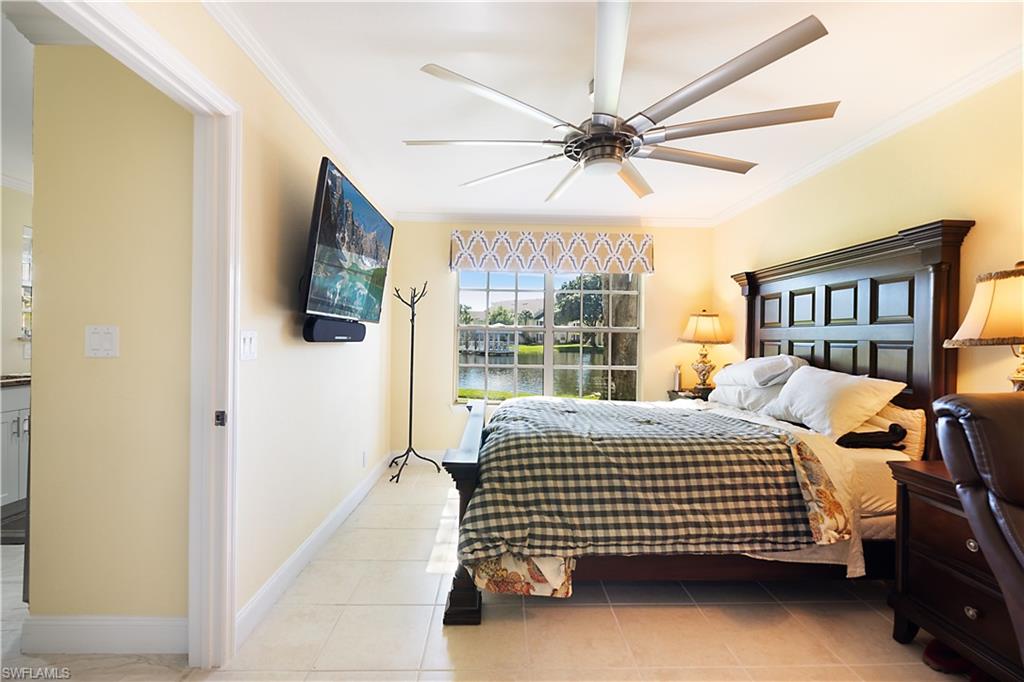 2008 Rookery Bay Drive, Unit 1102 Naples, FL 34114 - Photo 9 of 34 a bedroom with a bed a flat screen tv and a window