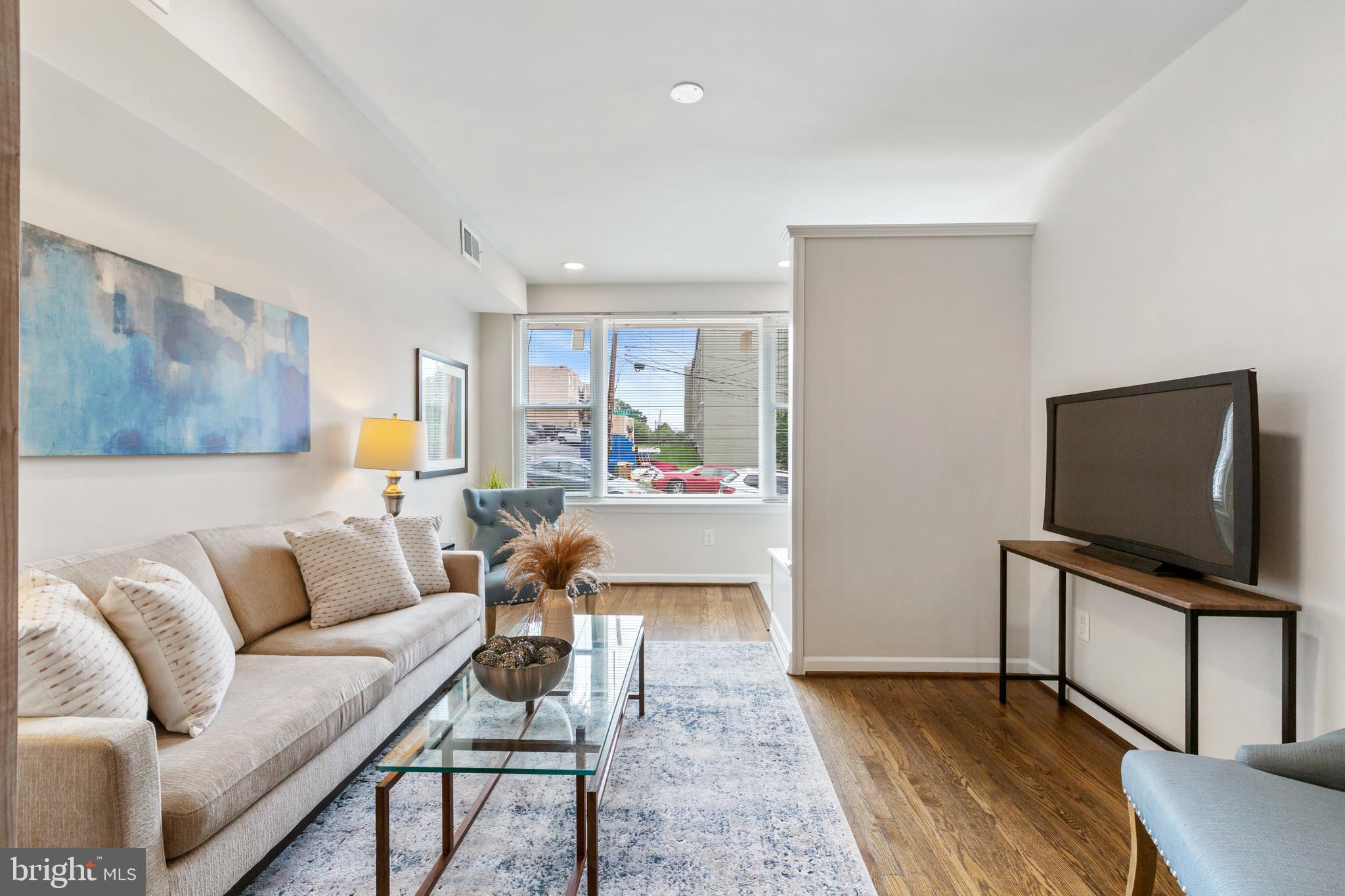 53 Victor Street Northeast, Unit 1 Washington, DC 20011 - Photo 6 of 18 a living room with furniture and a flat screen tv