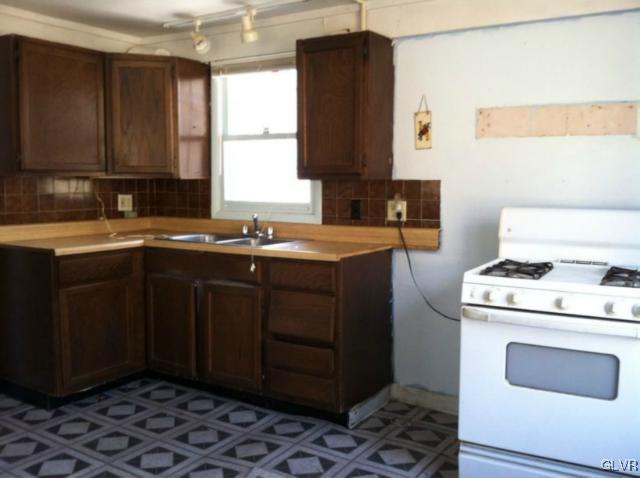 3074 South Oaks Road Bath, PA 18014 - Photo 3 of 12 a kitchen with a sink stove and cabinets