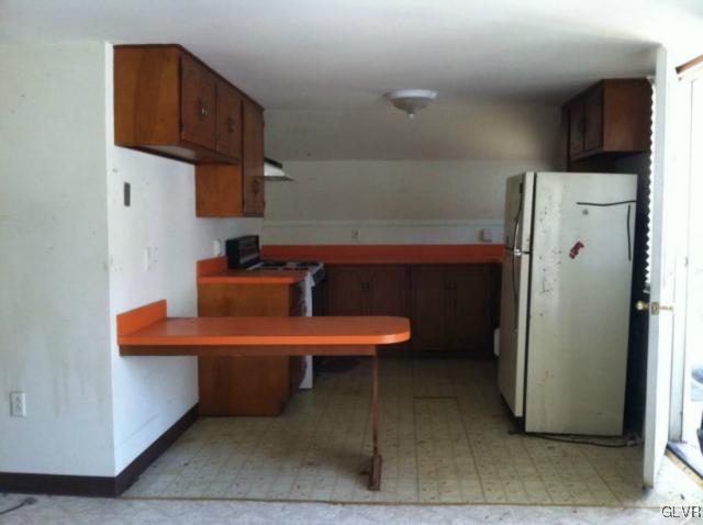 3074 South Oaks Road Bath, PA 18014 - Photo 9 of 12 a room with furniture a refrigerator and a sink