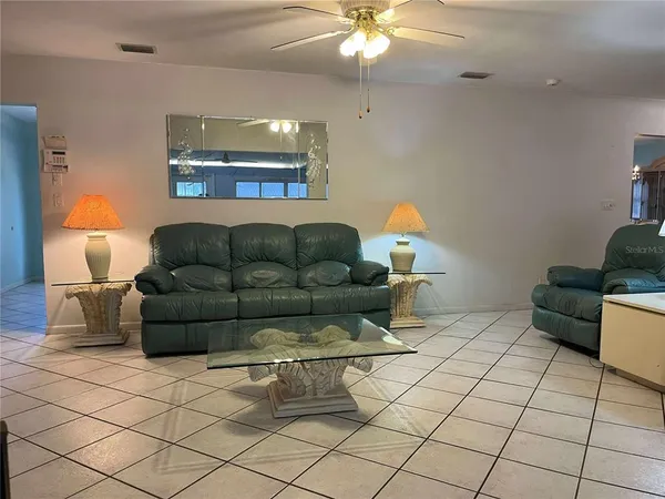 a living room with furniture and a chandelier