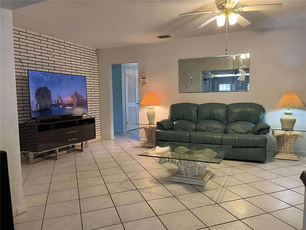 608 Knowles Road Brandon, FL 33511 - Photo 12 of 41 a living room with furniture and a flat screen tv