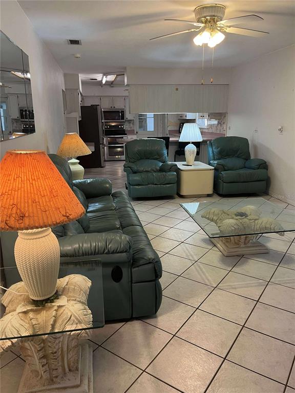 608 Knowles Road Brandon, FL 33511 - Photo 13 of 41 a living room with furniture and a chandelier