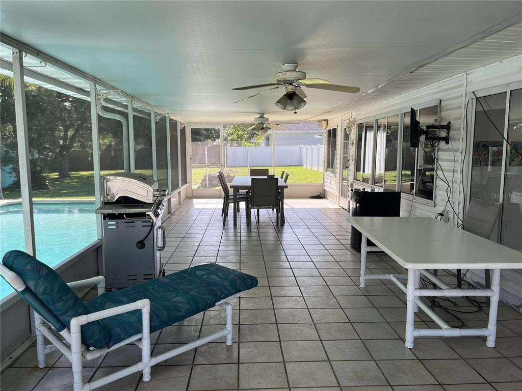 608 Knowles Road Brandon, FL 33511 - Photo 20 of 41 a dining room with furniture a chandelier and wooden floor
