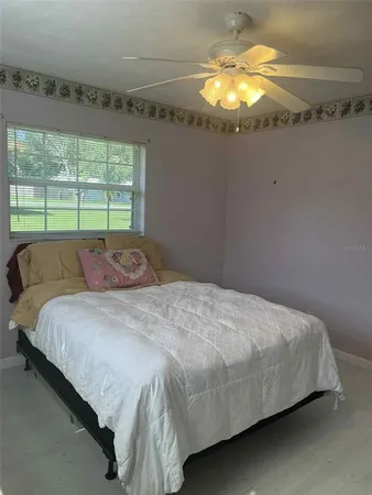 a bed sitting in a bedroom next to a window