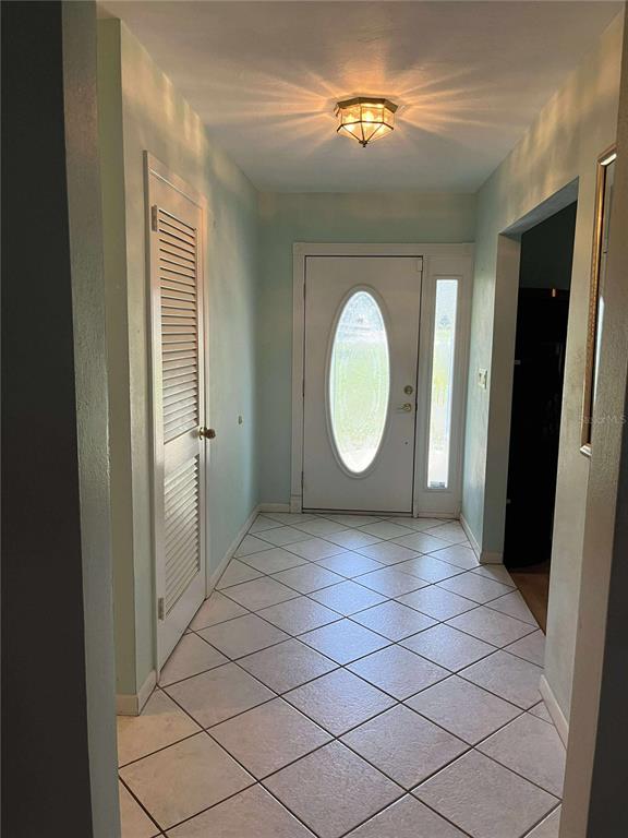 608 Knowles Road Brandon, FL 33511 - Photo 3 of 41 a view of a room with wooden floor fan and window