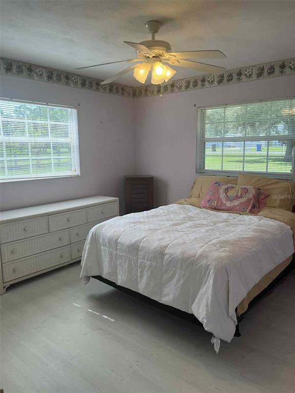 608 Knowles Road Brandon, FL 33511 - Photo 32 of 41 a bedroom with a bed and a chandelier