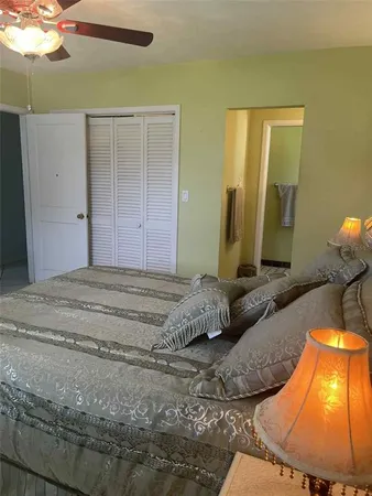 a bedroom with a bed and a mirror