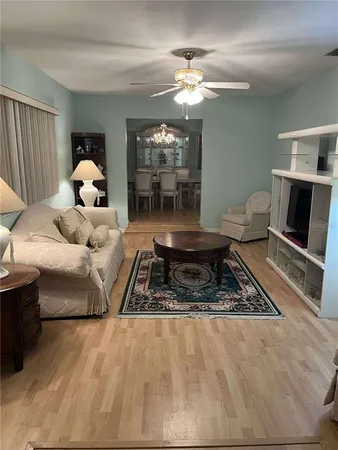 a living room with furniture and a chandelier